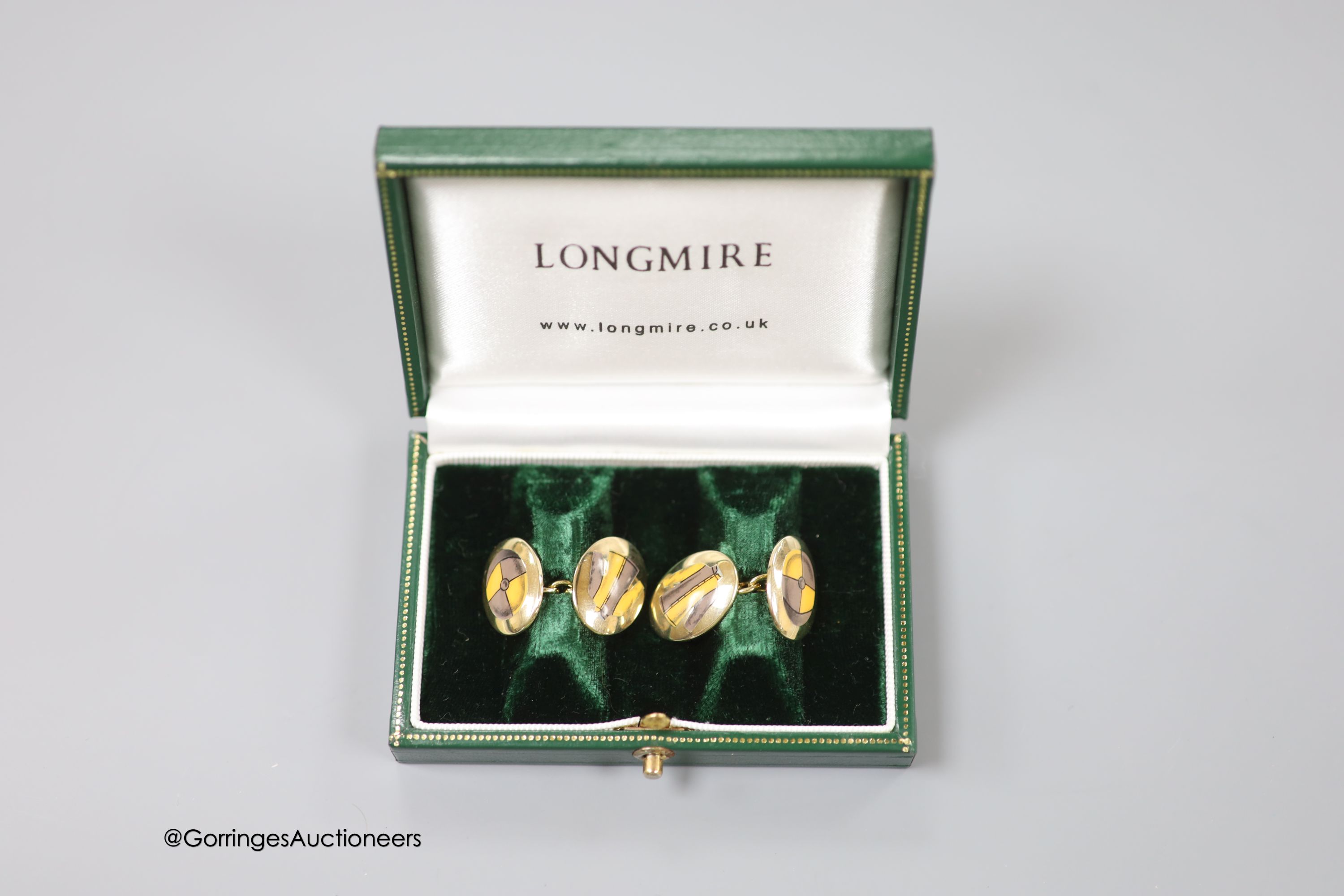 A cased modern pair of silver gilt and enamel Longmire oval cufflinks, decorated with jockey cap and colours, 19mm, gross weight 16.2 grams.